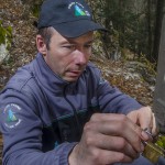 Swiss warden setting up a camera trap for the monitoring of the lynx in the Jura mountains.